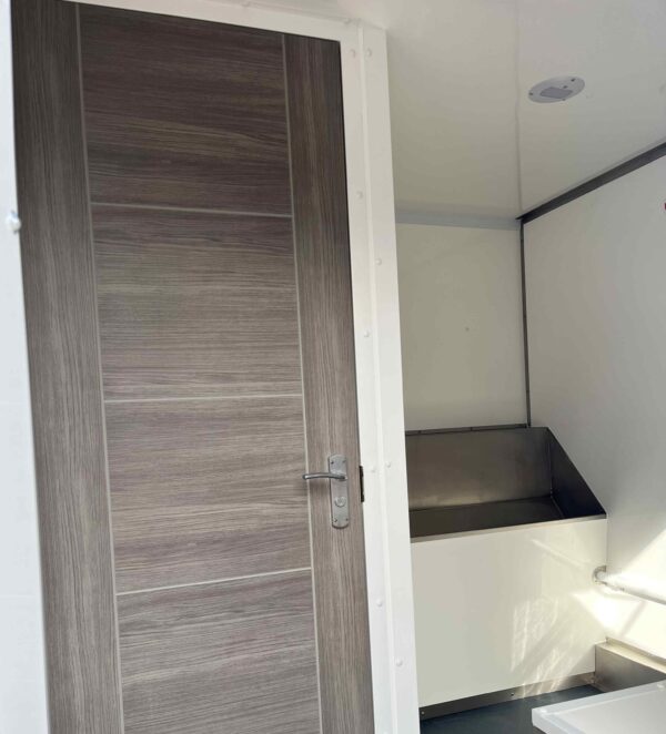 Internal view of toilet facilities within the toilet block hire unit from Enable Welfare
